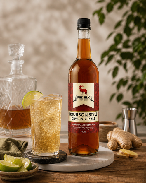 Bottle of Bourbon Style Dry Ginger Ale syrup with an alcohol fee cocktail glass.