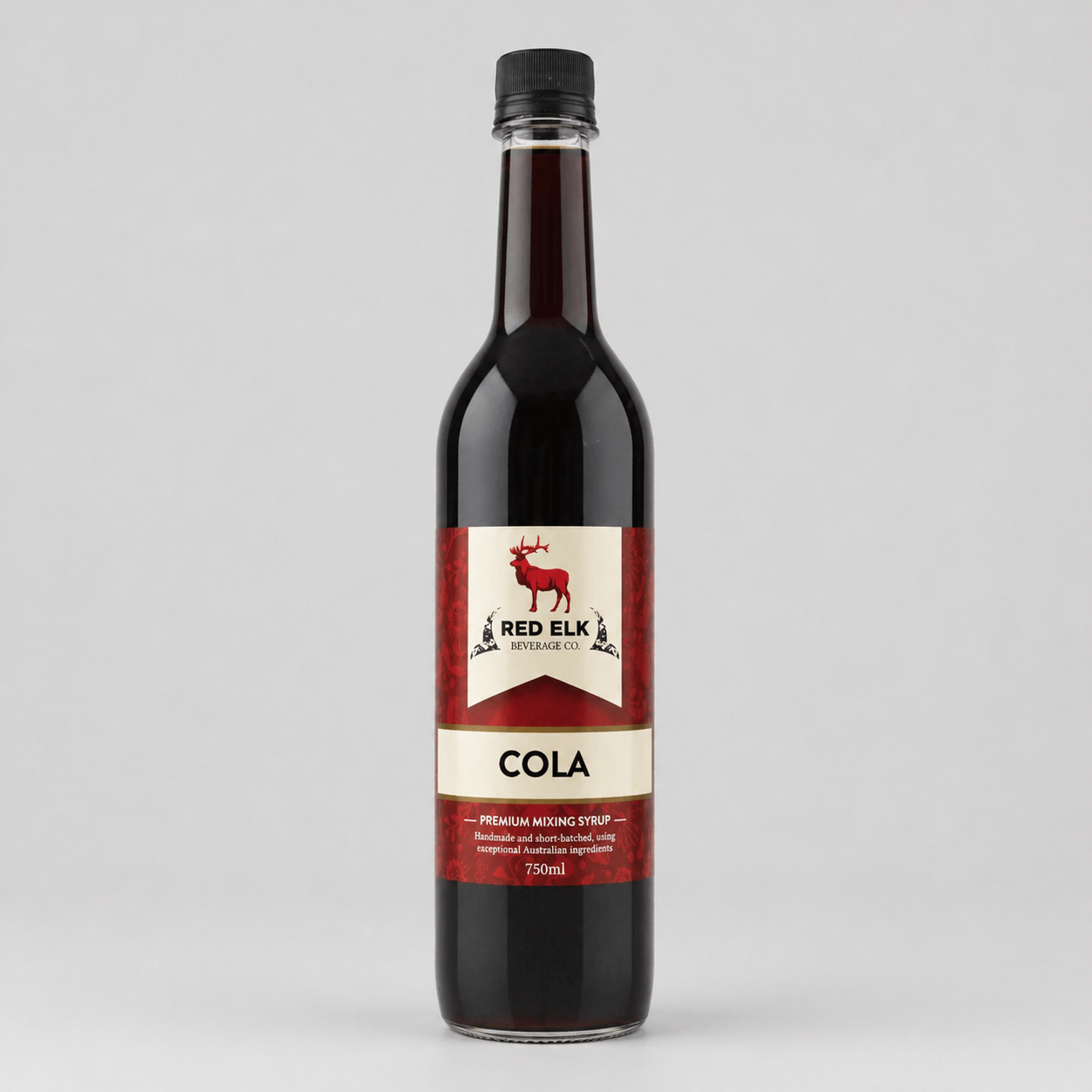 Bottle of Red Elk Cola syrup on a gray background