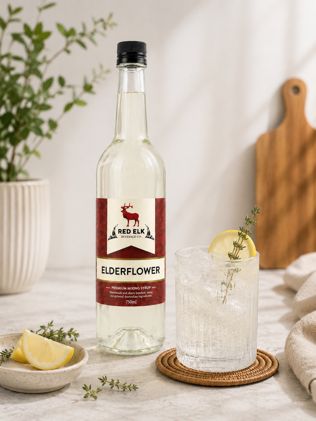 Bottle of Elderflower syrup with mocktail