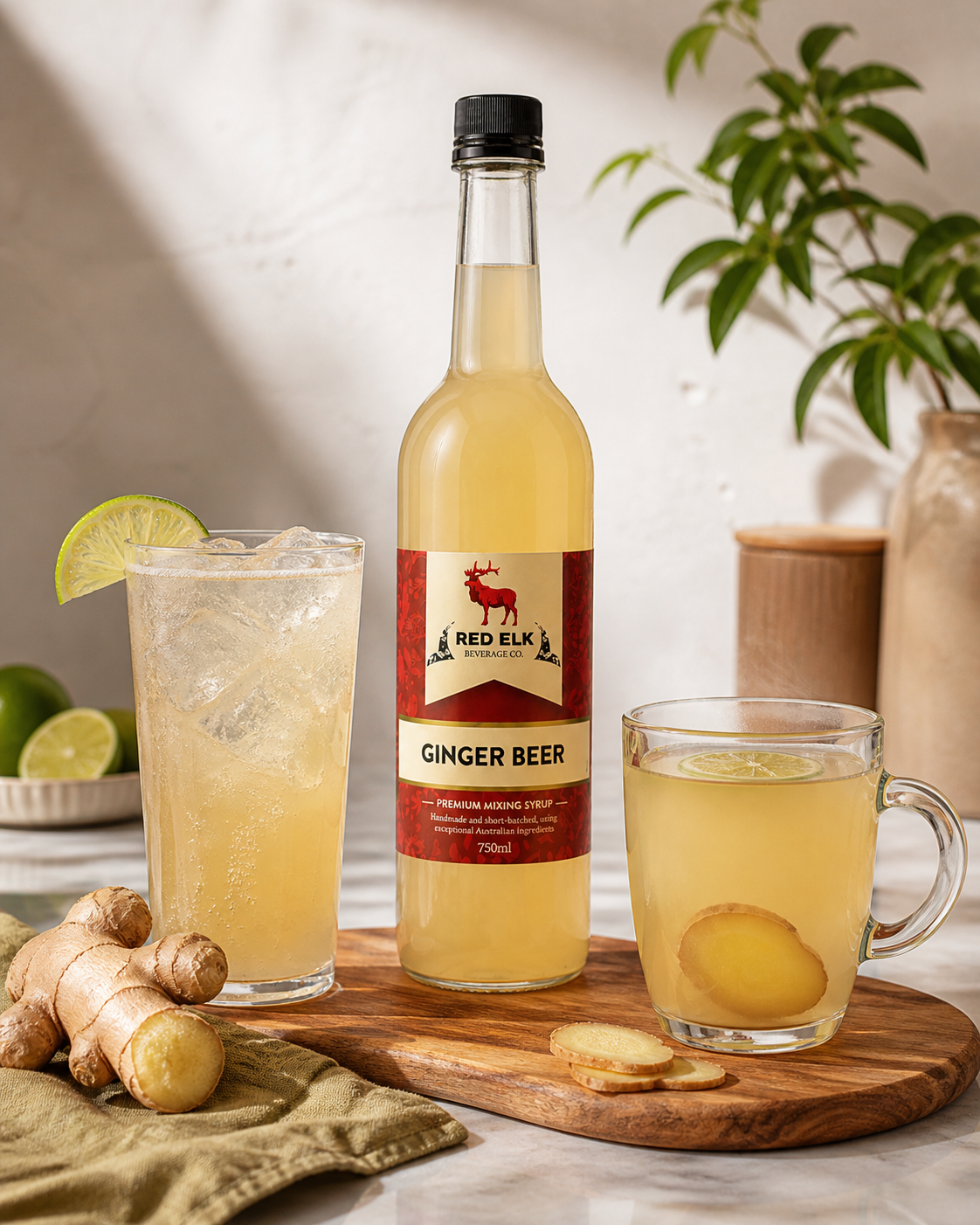 Bottle of Red Elk Ginger Beer with two glasses filled with a ginger beer drink on a wooden board.