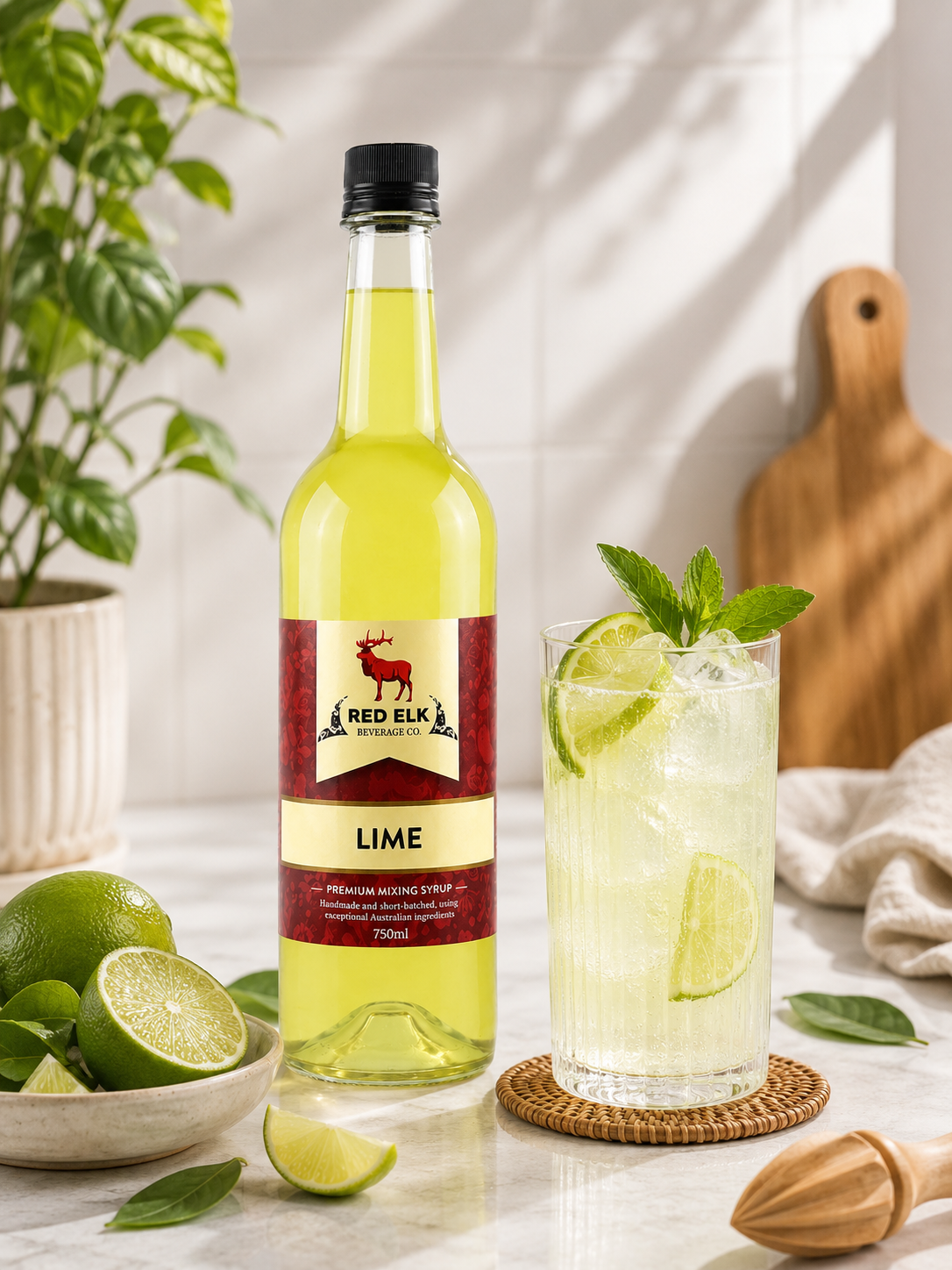 Bottle of Red Elk Lime syrup with a glass of lime mocktail.