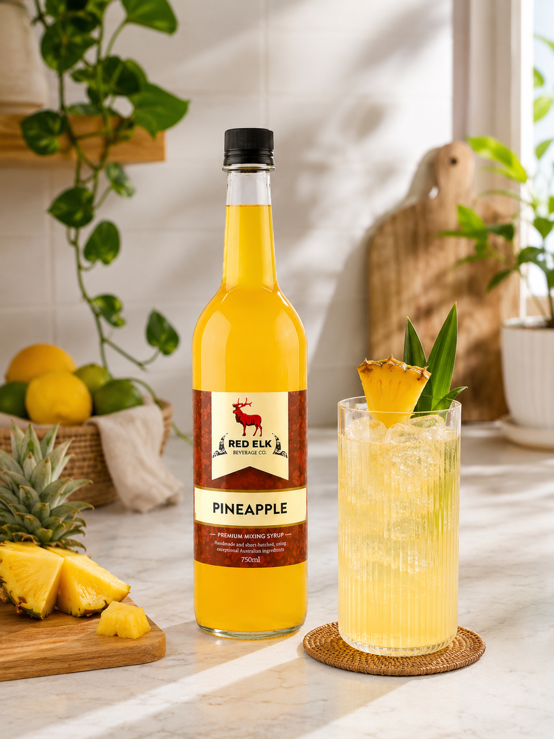 Bottle of Red Elk Pineapple with a glass of soda garnished with pineapple on a table.