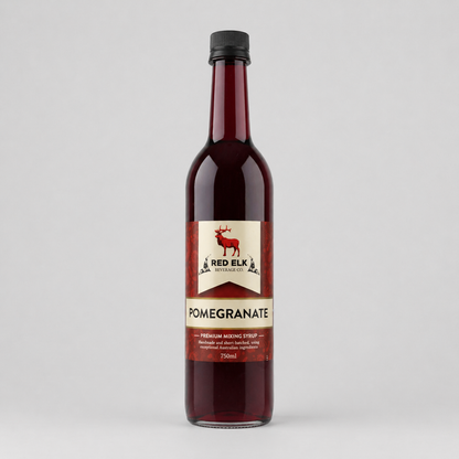Bottle of Red Elk Pomegranate syrup on a gray background
