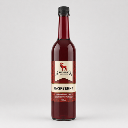 Bottle of Red Elk Raspberry syrup on a light gray background